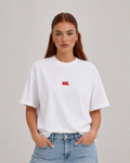 Woman wearing white WAG slogan t-shirt with red chest print